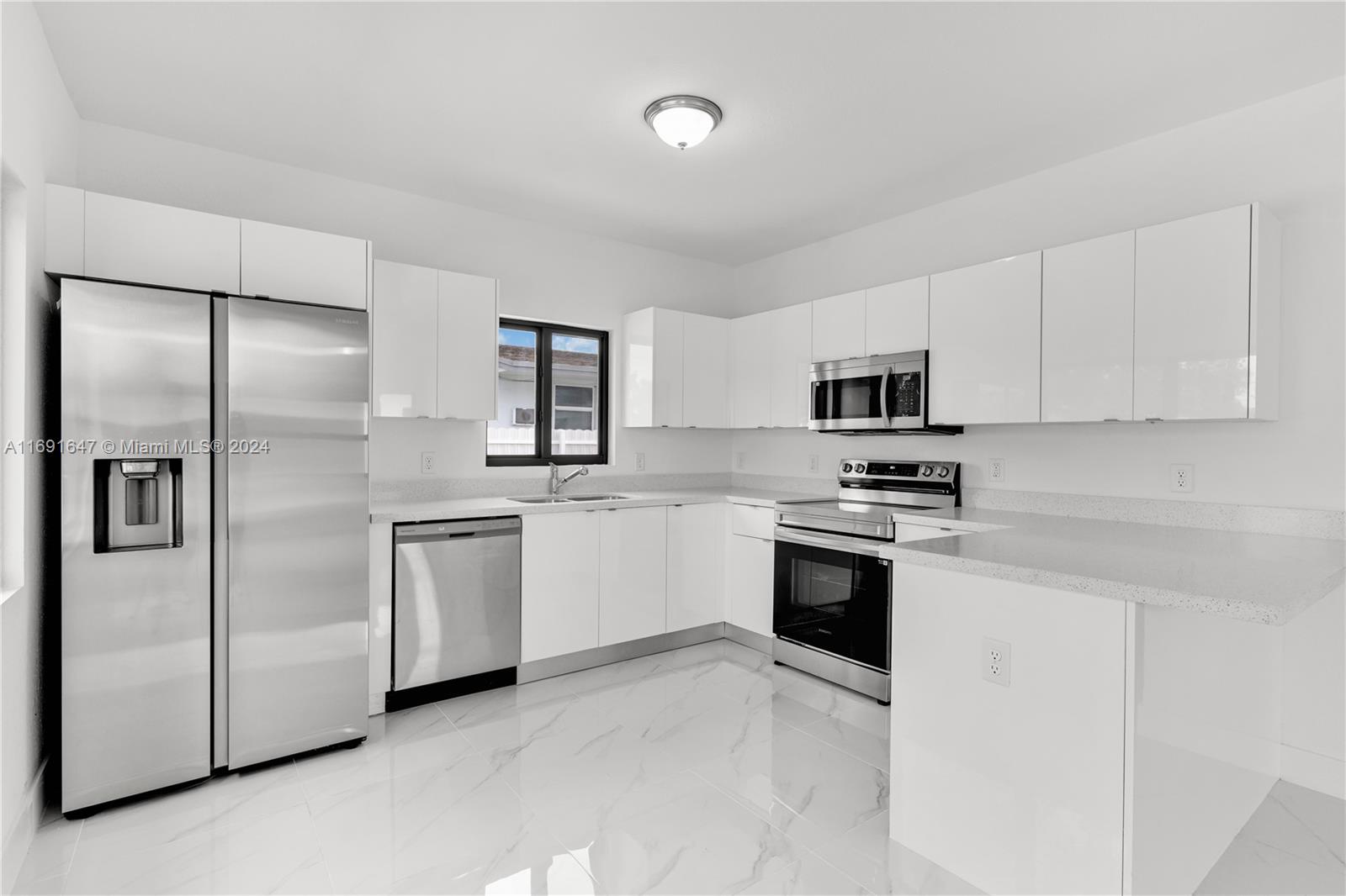 11970 Southwest 213th Street, Unit 1 Miami, FL 33177 - Photo 9 of 36 a kitchen with cabinets stainless steel appliances and sink