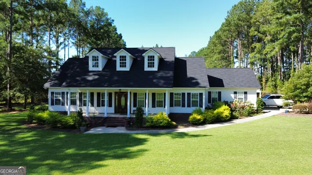 a front view of a house with garden and porch
