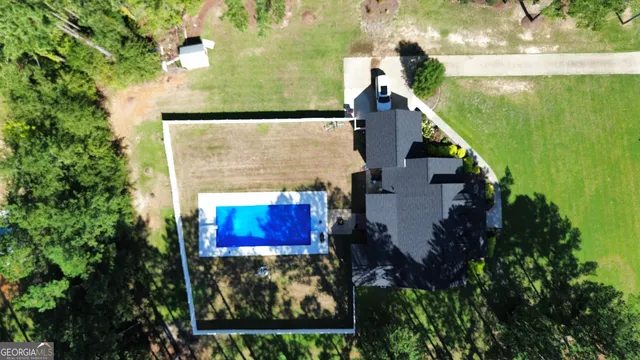 an aerial view of a house with a yard basket ball court and outdoor seating