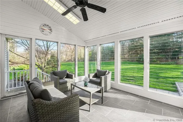 a living room with furniture and a floor to ceiling window