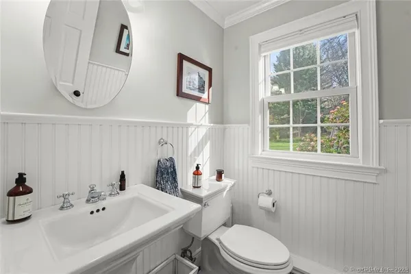 a white toilet sitting next to a bathroom sink