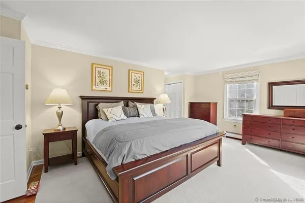 a bed room with a bed and a dresser