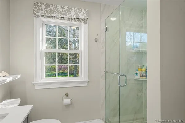 a bathroom with a window and toilet