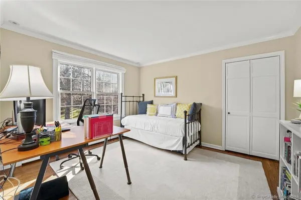 a living room with furniture a flat screen tv and a floor to ceiling window