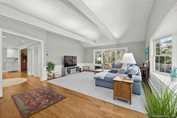 a living room with furniture large window and a flat screen tv