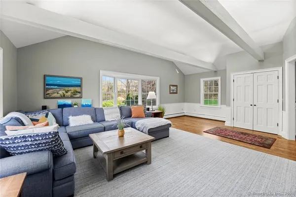a living room with furniture and a wooden floor