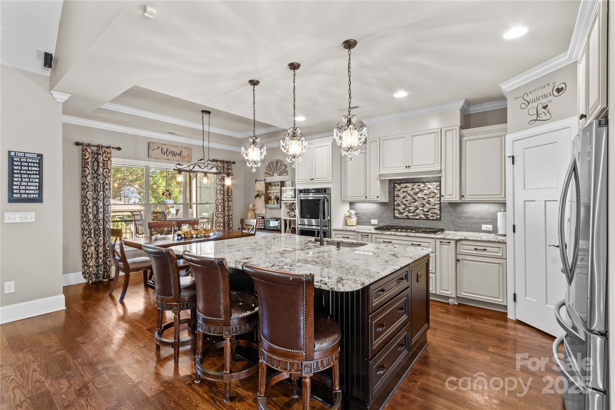 8612 Amandine Way Terrell, NC 28682 - Photo 12 of 48 a kitchen with center island white cabinets and stainless steel appliances