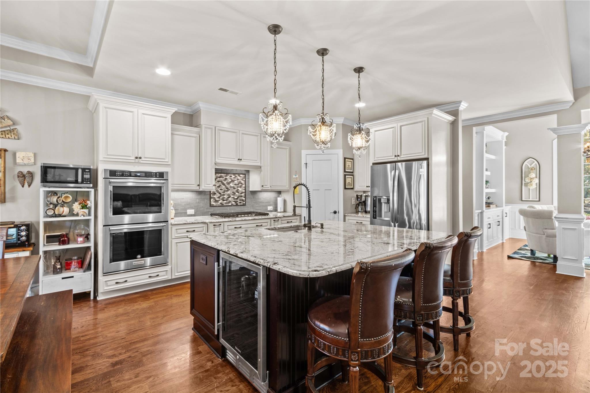 8612 Amandine Way Terrell, NC 28682 - Photo 14 of 48 a kitchen with stainless steel appliances kitchen island granite countertop a table chairs and a refrigerator