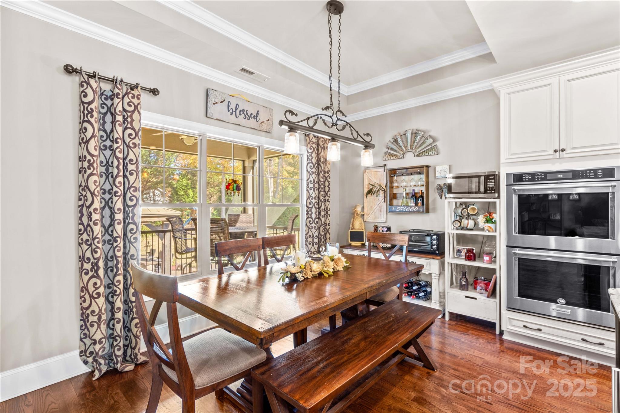8612 Amandine Way Terrell, NC 28682 - Photo 16 of 48 a living room with furniture a chandelier and a flat screen tv