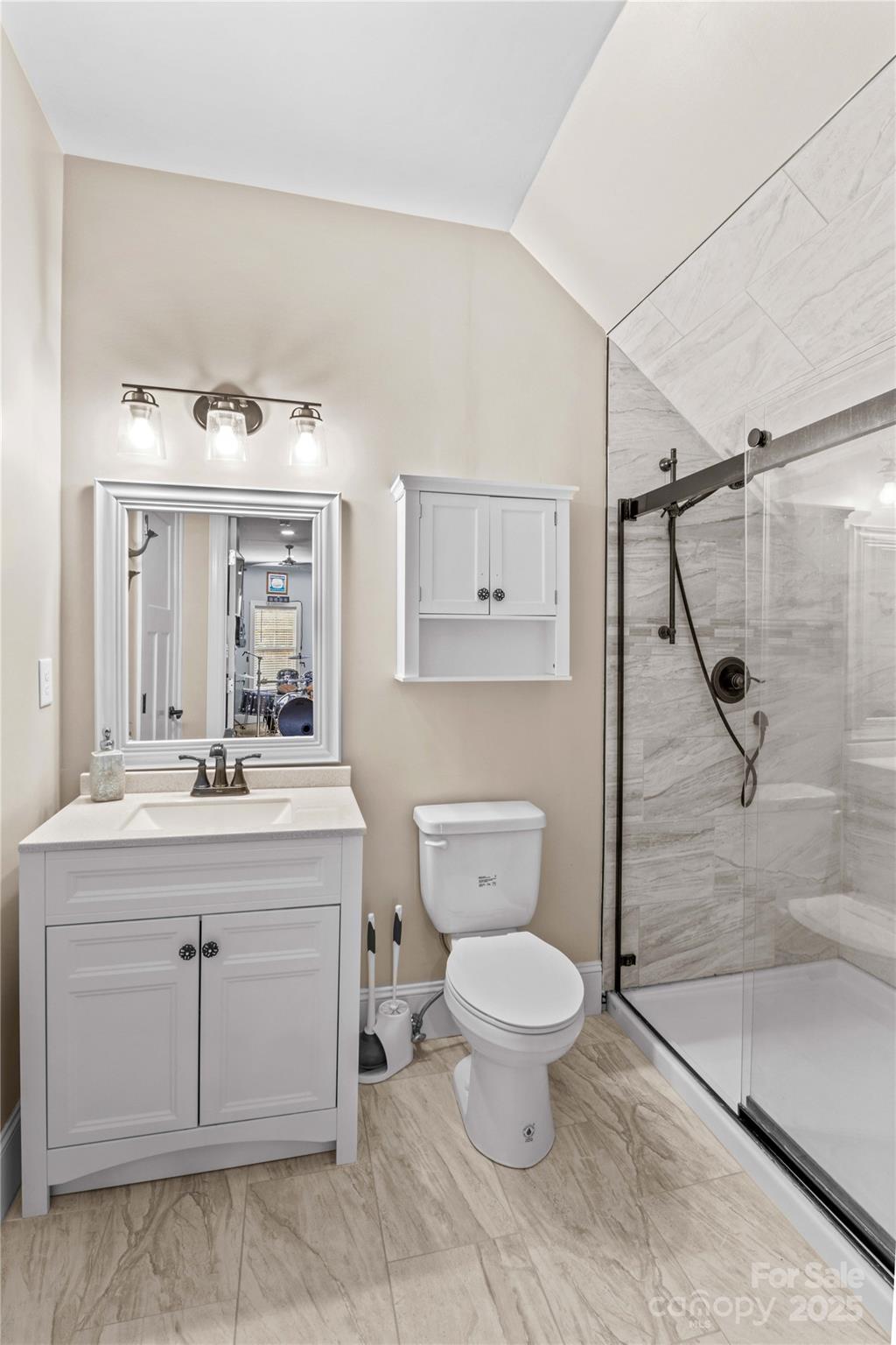 8612 Amandine Way Terrell, NC 28682 - Photo 27 of 48 a bathroom with a granite countertop sink toilet a mirror and shower