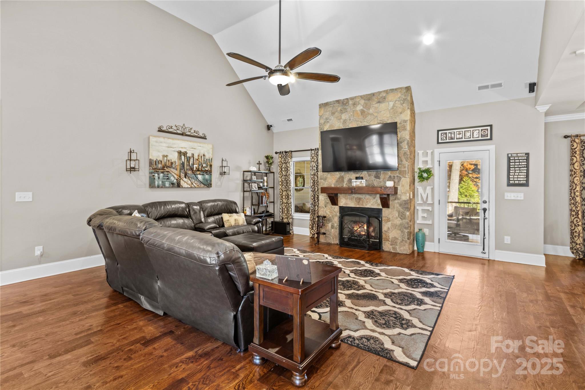 8612 Amandine Way Terrell, NC 28682 - Photo 9 of 48 a living room with furniture a flat screen tv and a fireplace