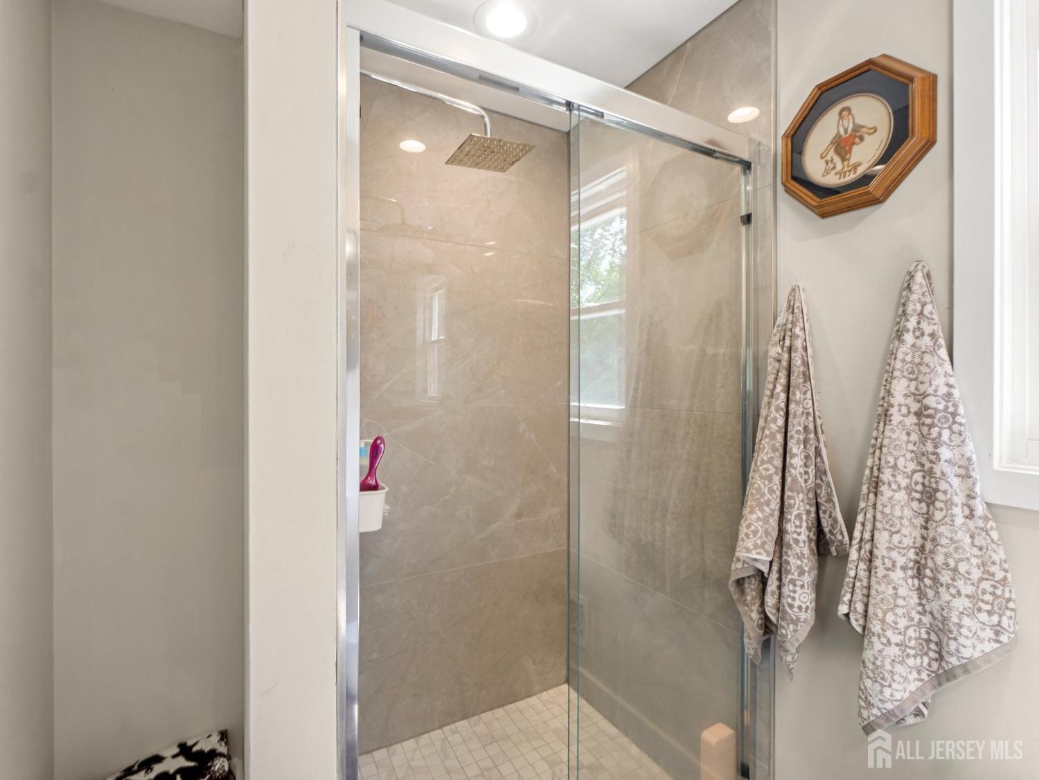 19 Wolf Drive Hamilton, NJ 08610 - Photo 11 of 24 a bathroom with a shower and a mirror