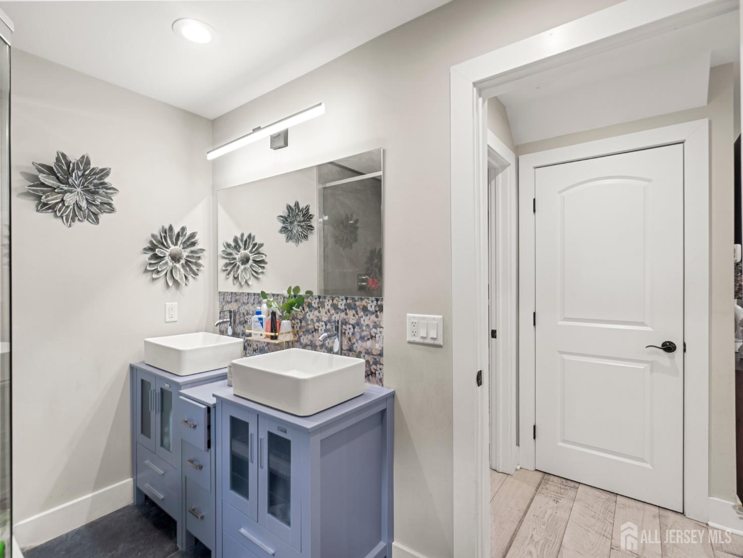 19 Wolf Drive Hamilton, NJ 08610 - Photo 16 of 24 a bathroom with a sink a mirror and a vanity