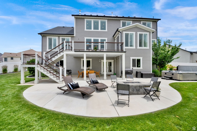 1132 South 1300th Street West Mapleton, UT 84664 - Photo 39 of 52 Expansive backyard featuring a large concrete patio, a stone fire pit, and a built-in outdoor spa