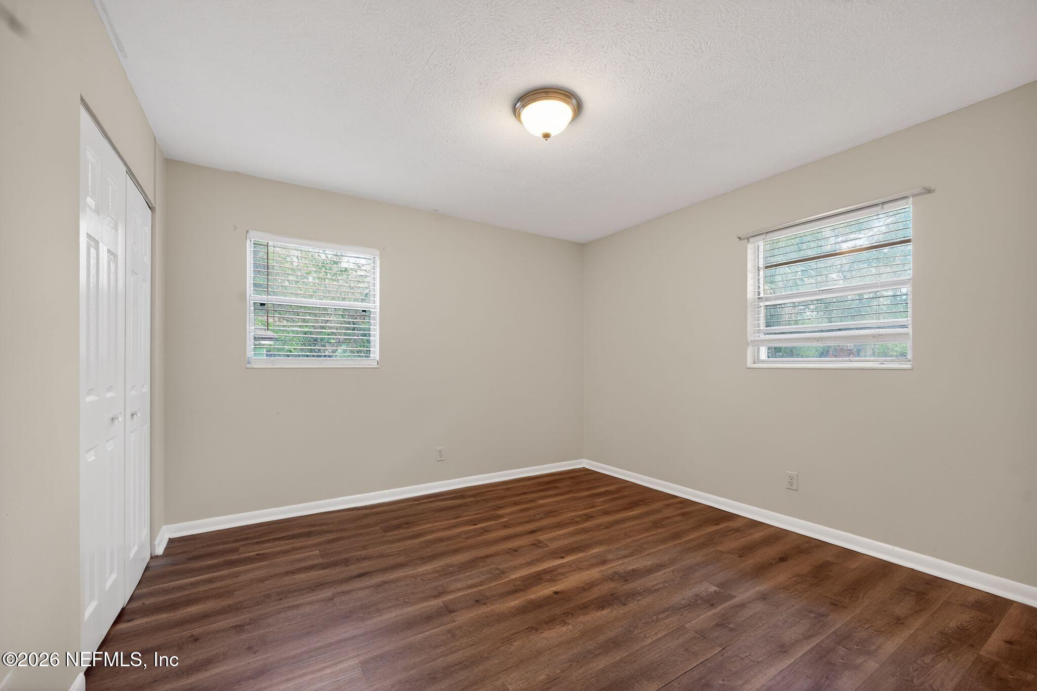 8609 Oak Leaf Road Jacksonville, FL 32208 - Photo 11 of 18 a view of room with wooden floor and window