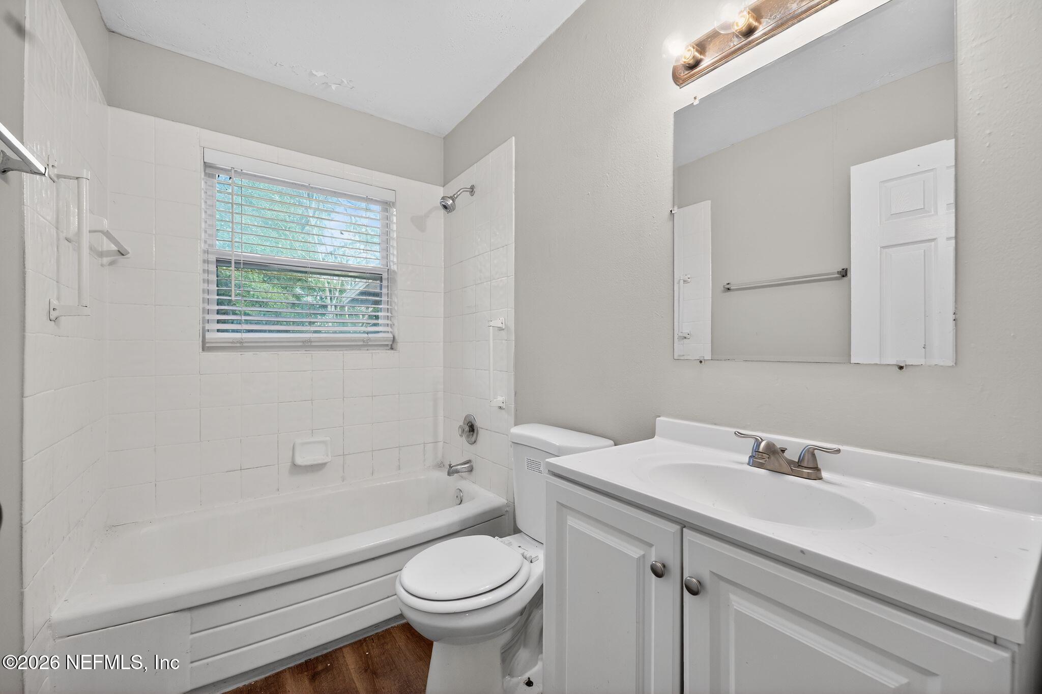 8609 Oak Leaf Road Jacksonville, FL 32208 - Photo 13 of 18 a bathroom with a sink toilet and shower