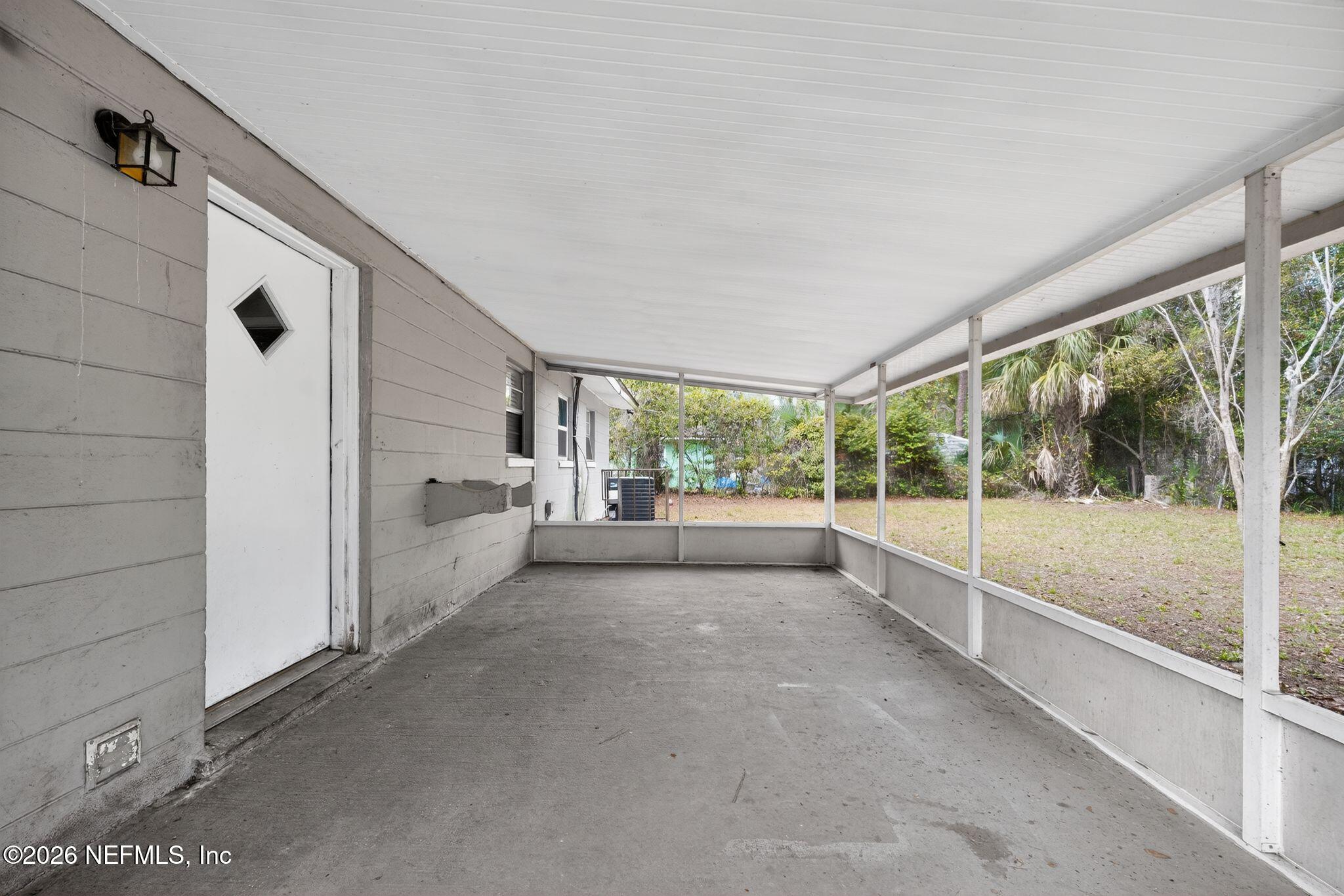 8609 Oak Leaf Road Jacksonville, FL 32208 - Photo 15 of 18 a view of a porch with wooden floor and front door