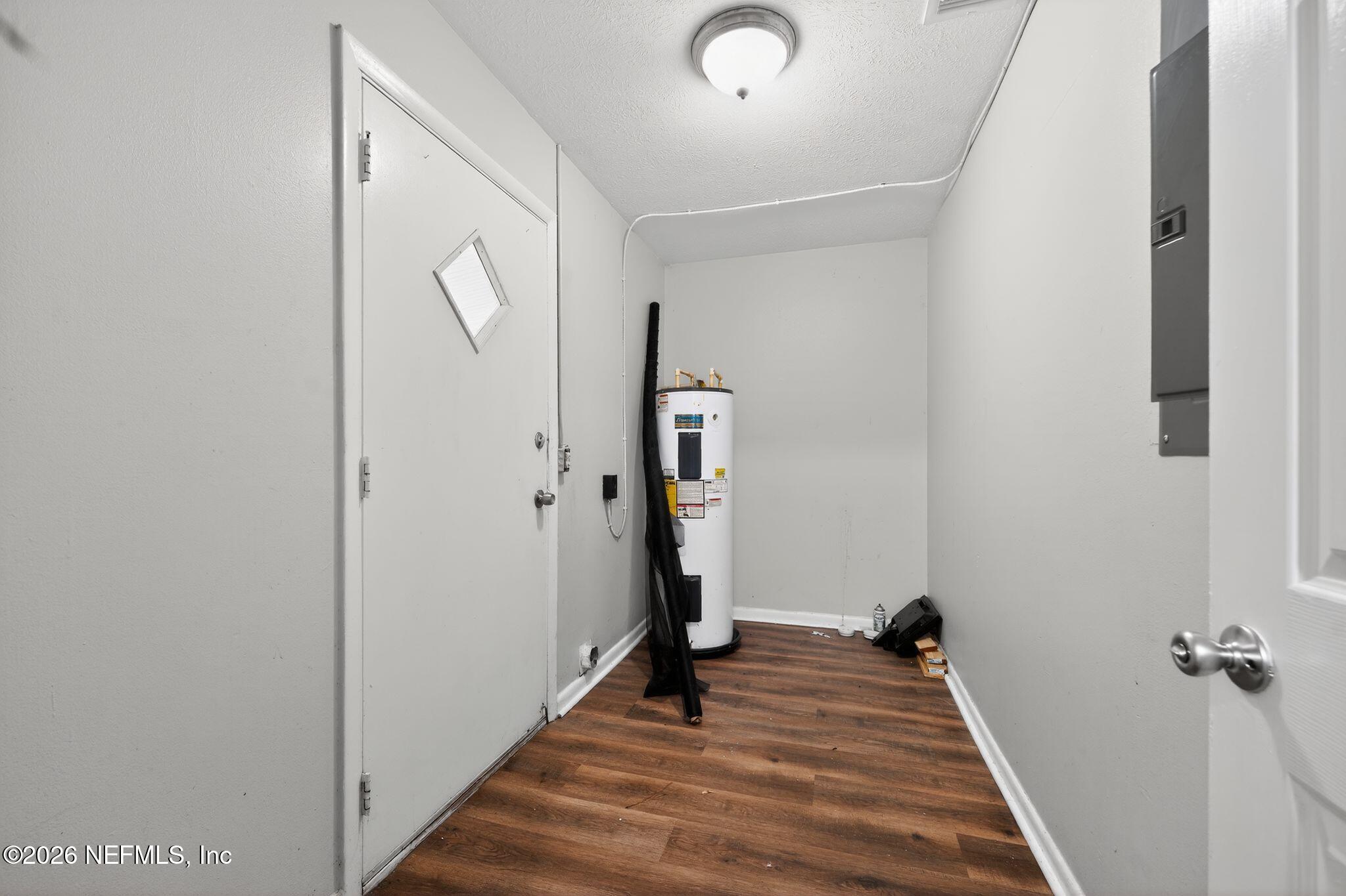 8609 Oak Leaf Road Jacksonville, FL 32208 - Photo 16 of 18 a view of a hallway with wooden floor and staircase