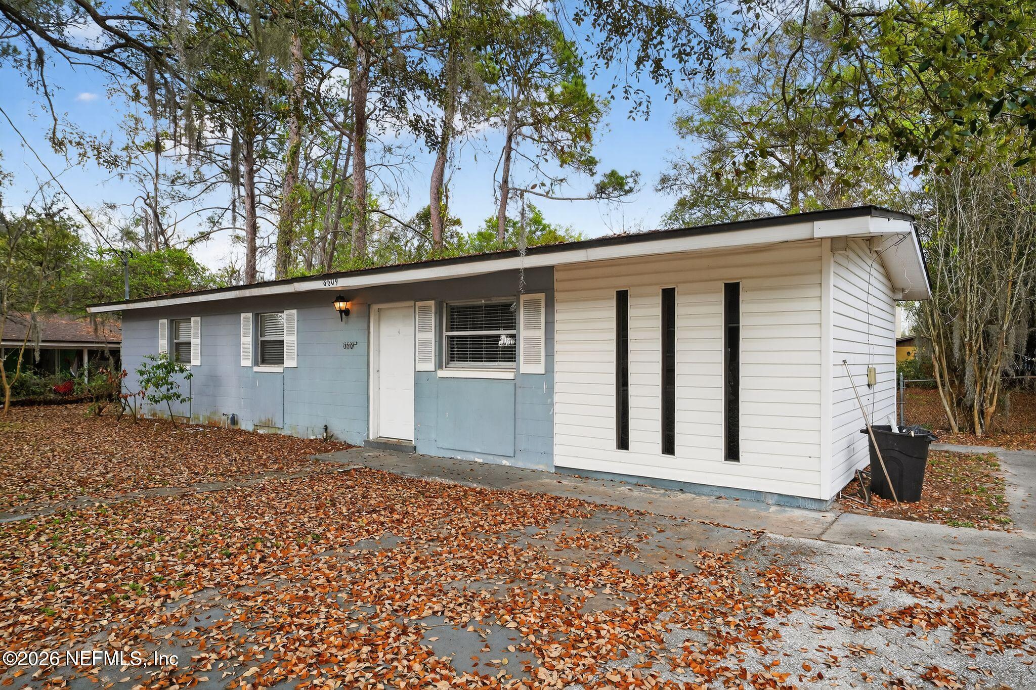 8609 Oak Leaf Road Jacksonville, FL 32208 - Photo 2 of 18 a backyard of a house with large trees
