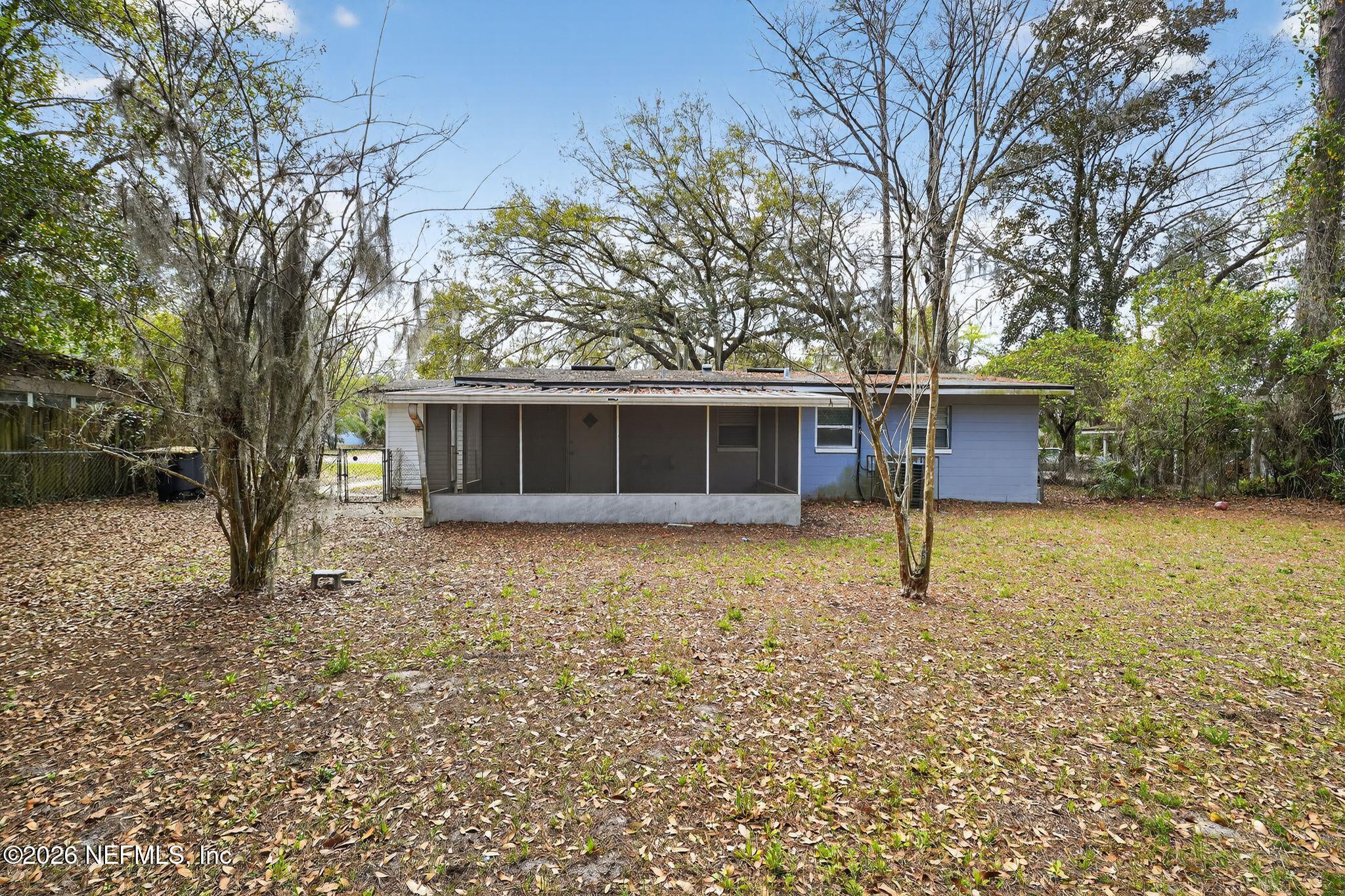 8609 Oak Leaf Road Jacksonville, FL 32208 - Photo 3 of 18 a house with trees in the background