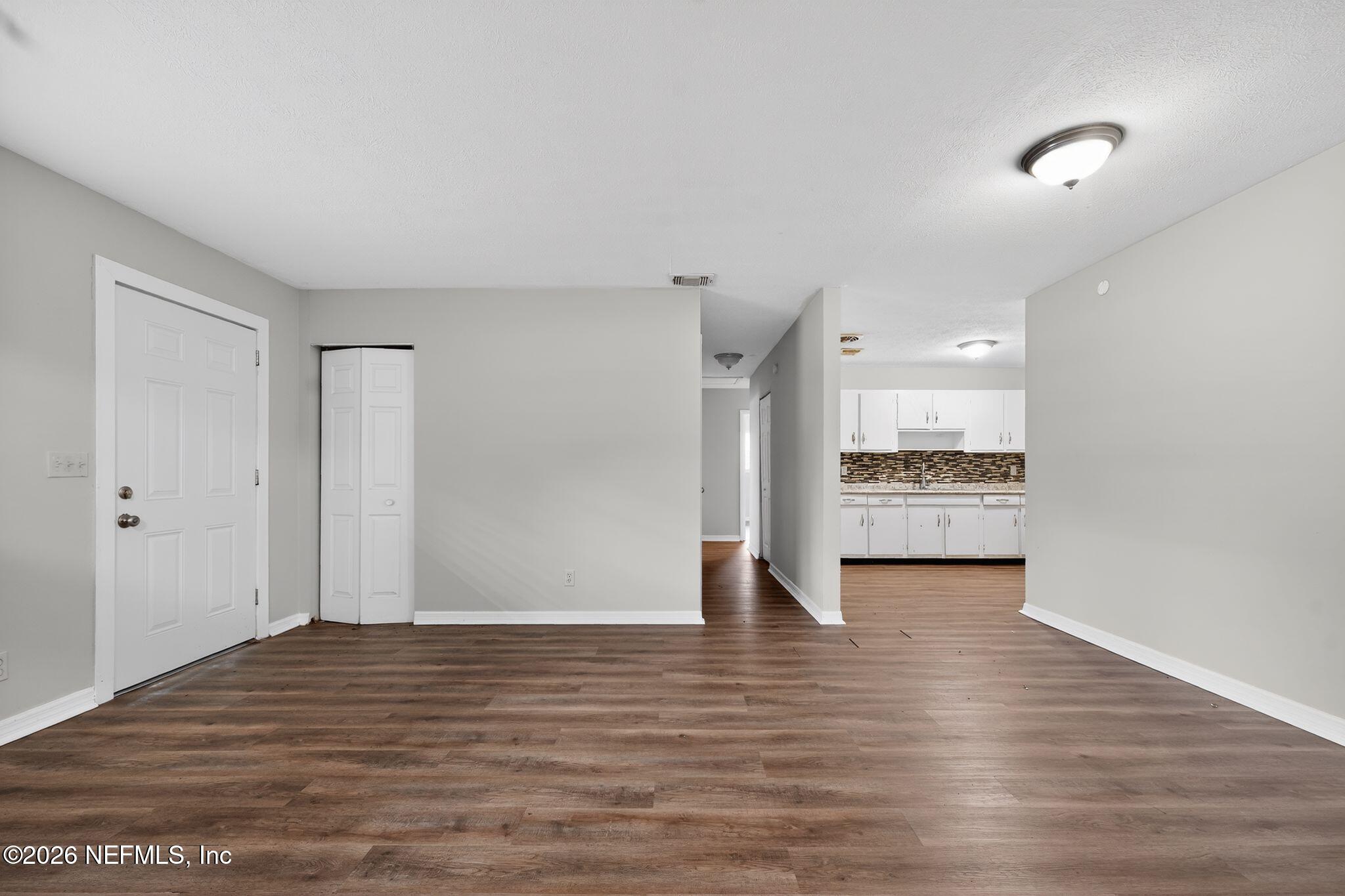 8609 Oak Leaf Road Jacksonville, FL 32208 - Photo 4 of 18 a view of empty room with wooden floor