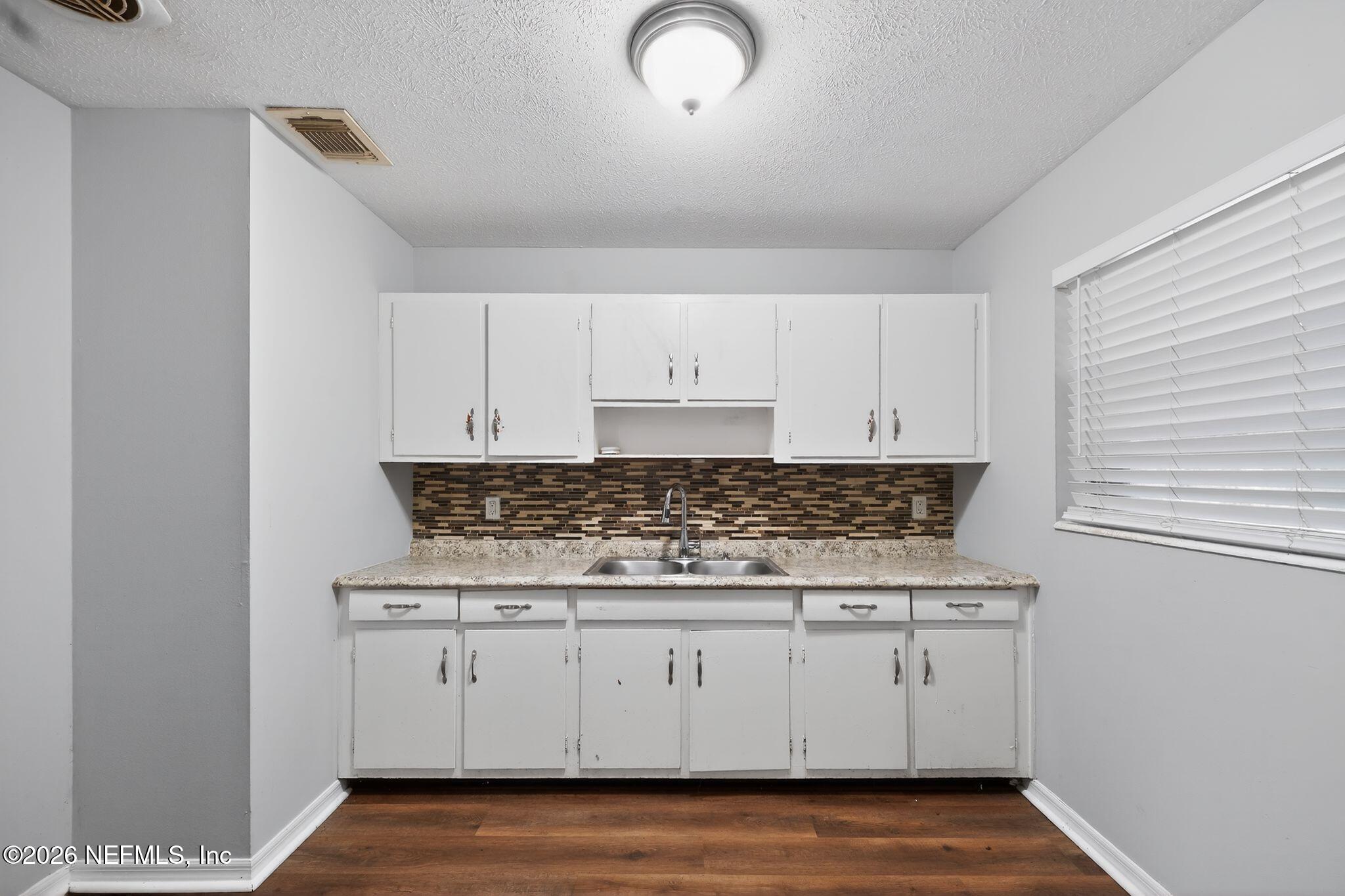 8609 Oak Leaf Road Jacksonville, FL 32208 - Photo 8 of 18 a stove top oven sitting inside of a kitchen