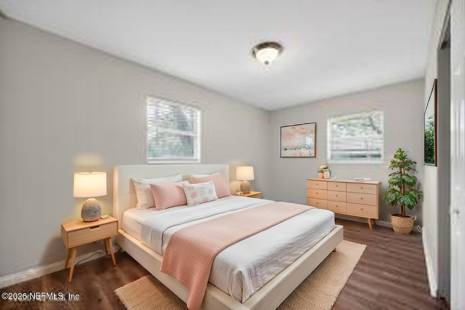 8609 Oak Leaf Road Jacksonville, FL 32208 - Photo 9 of 18 a bedroom with a bed and a potted plant