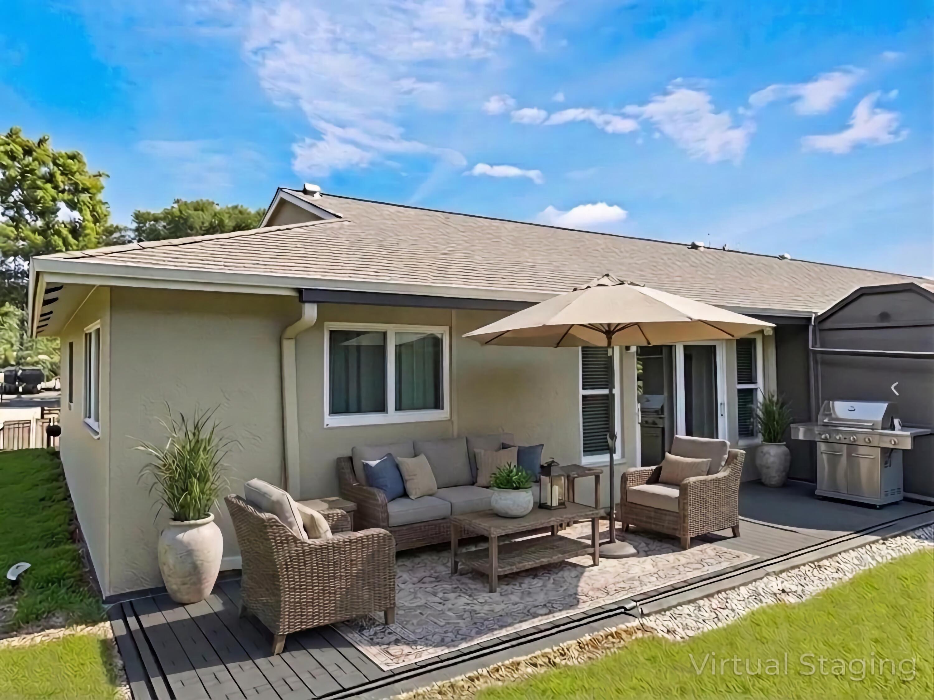 a patio with sofas table and chairs