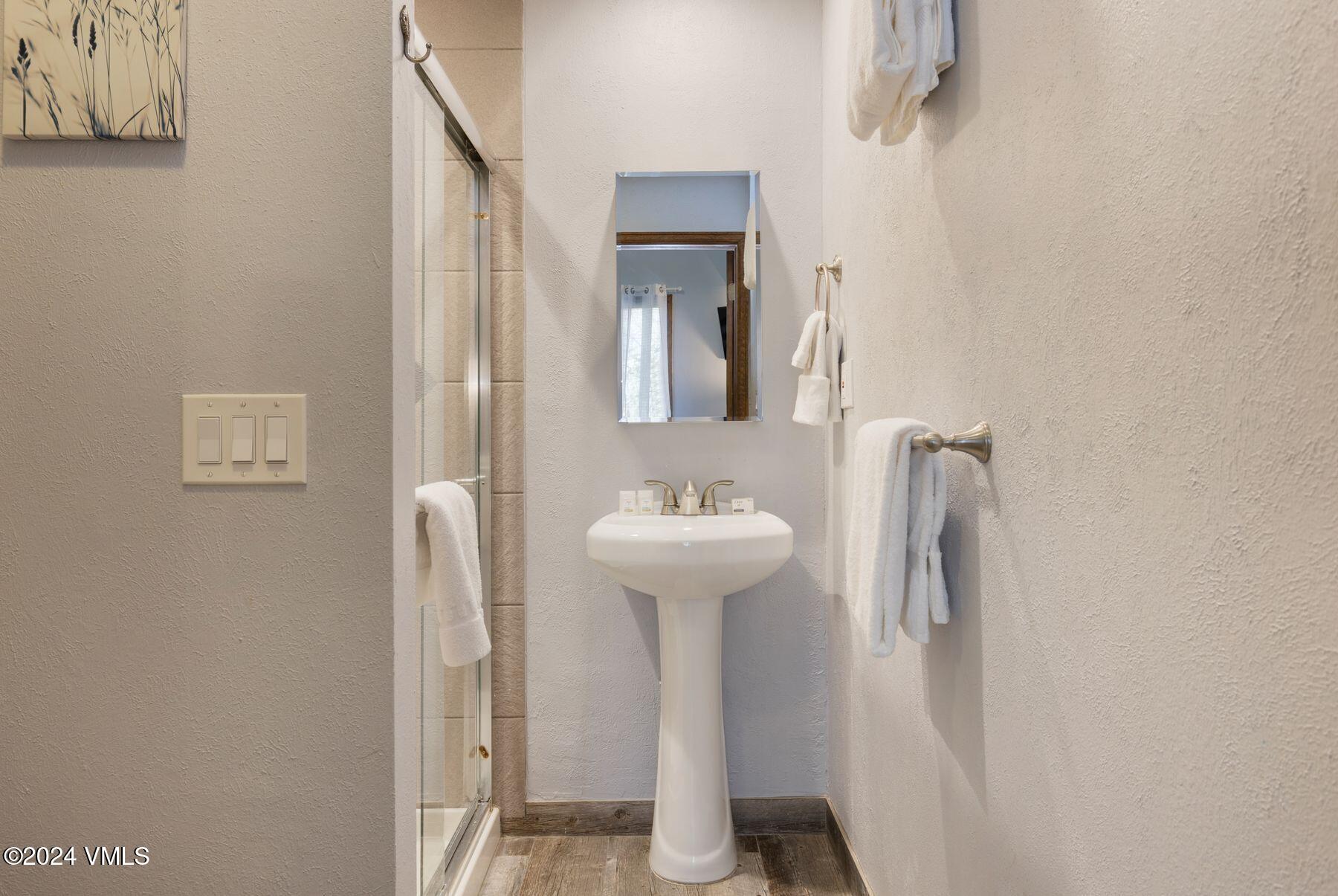 149 Deer Boulevard, Unit A Eagle-Vail, CO 81620 - Photo 16 of 22 a bathroom with a sink a toilet and mirror
