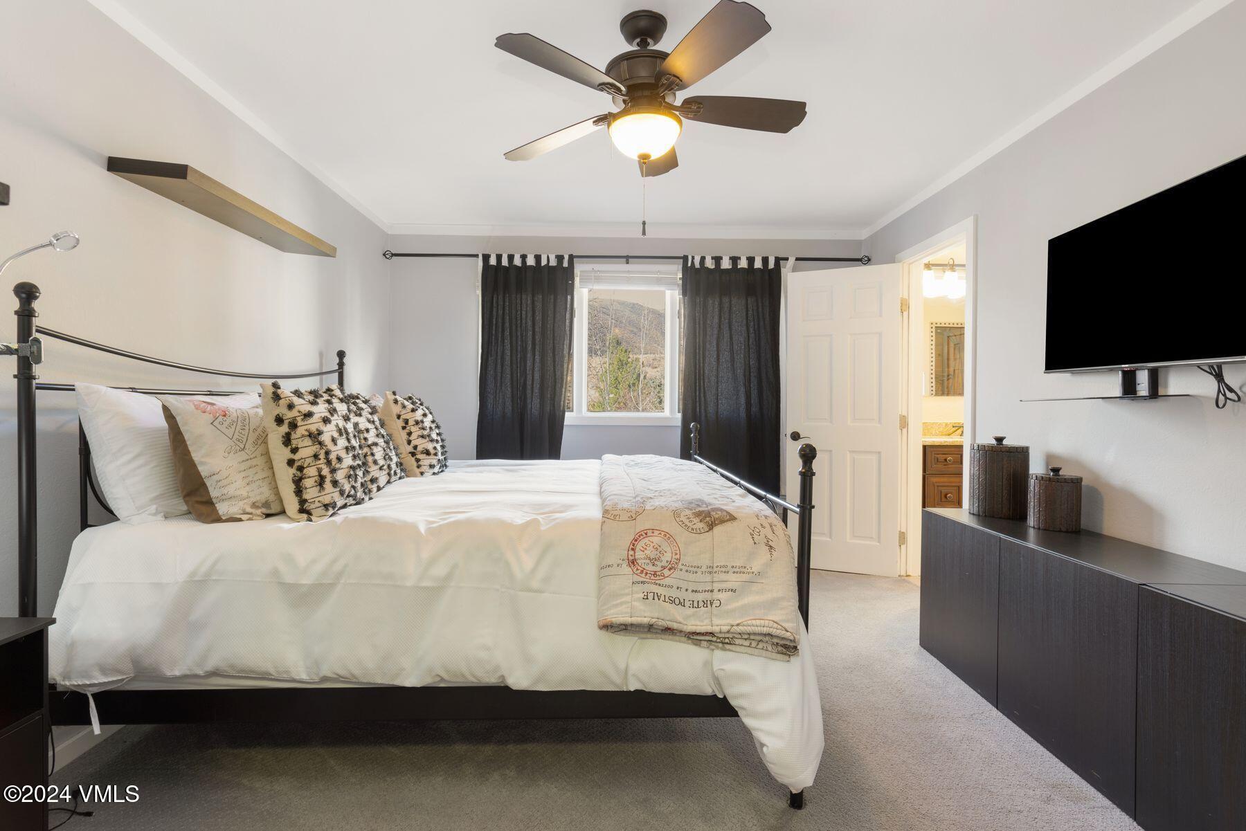 149 Deer Boulevard, Unit A Eagle-Vail, CO 81620 - Photo 17 of 22 a bedroom with a bed and a flat screen tv