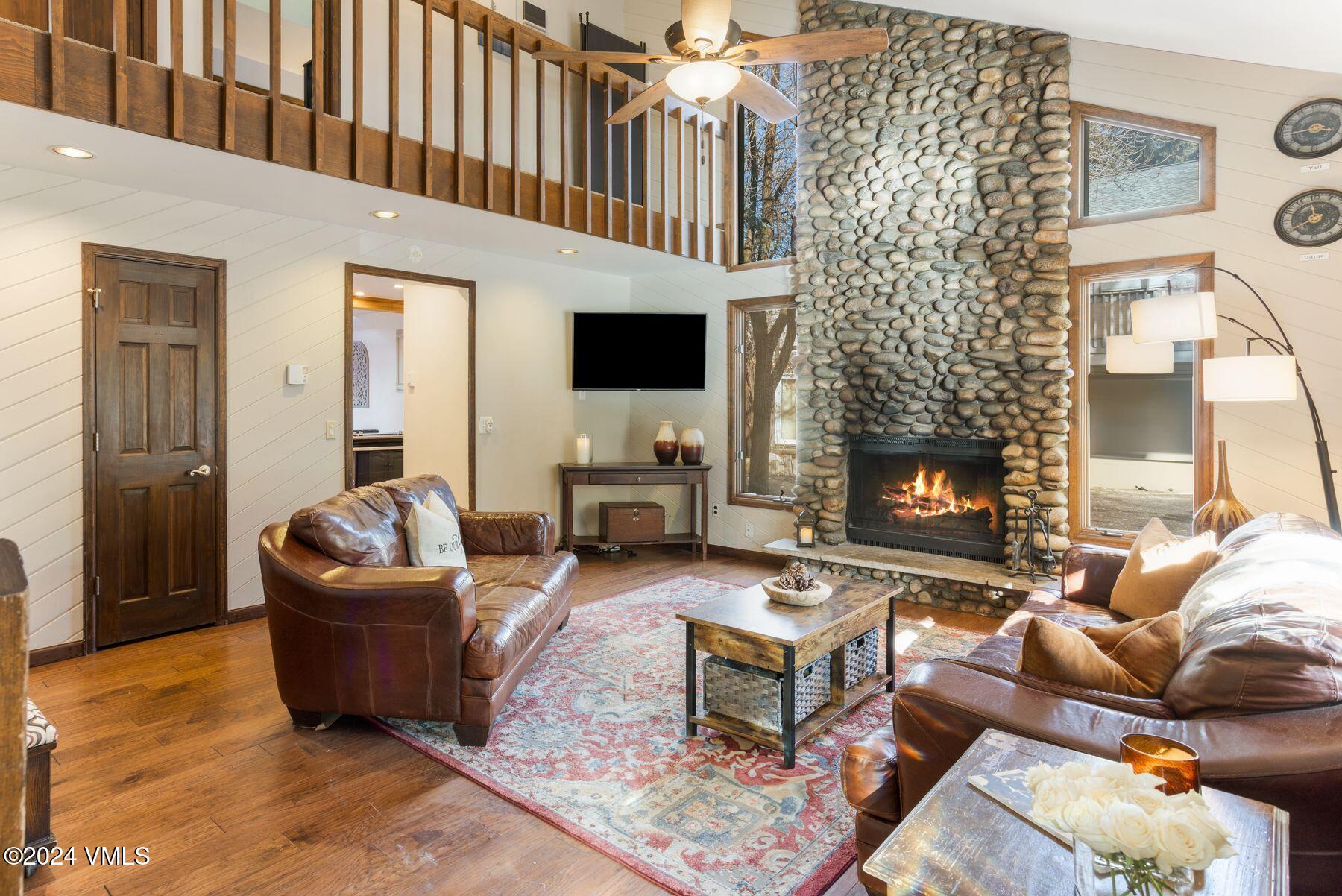 149 Deer Boulevard, Unit A Eagle-Vail, CO 81620 - Photo 7 of 22 a living room with furniture a flat screen tv and a fireplace