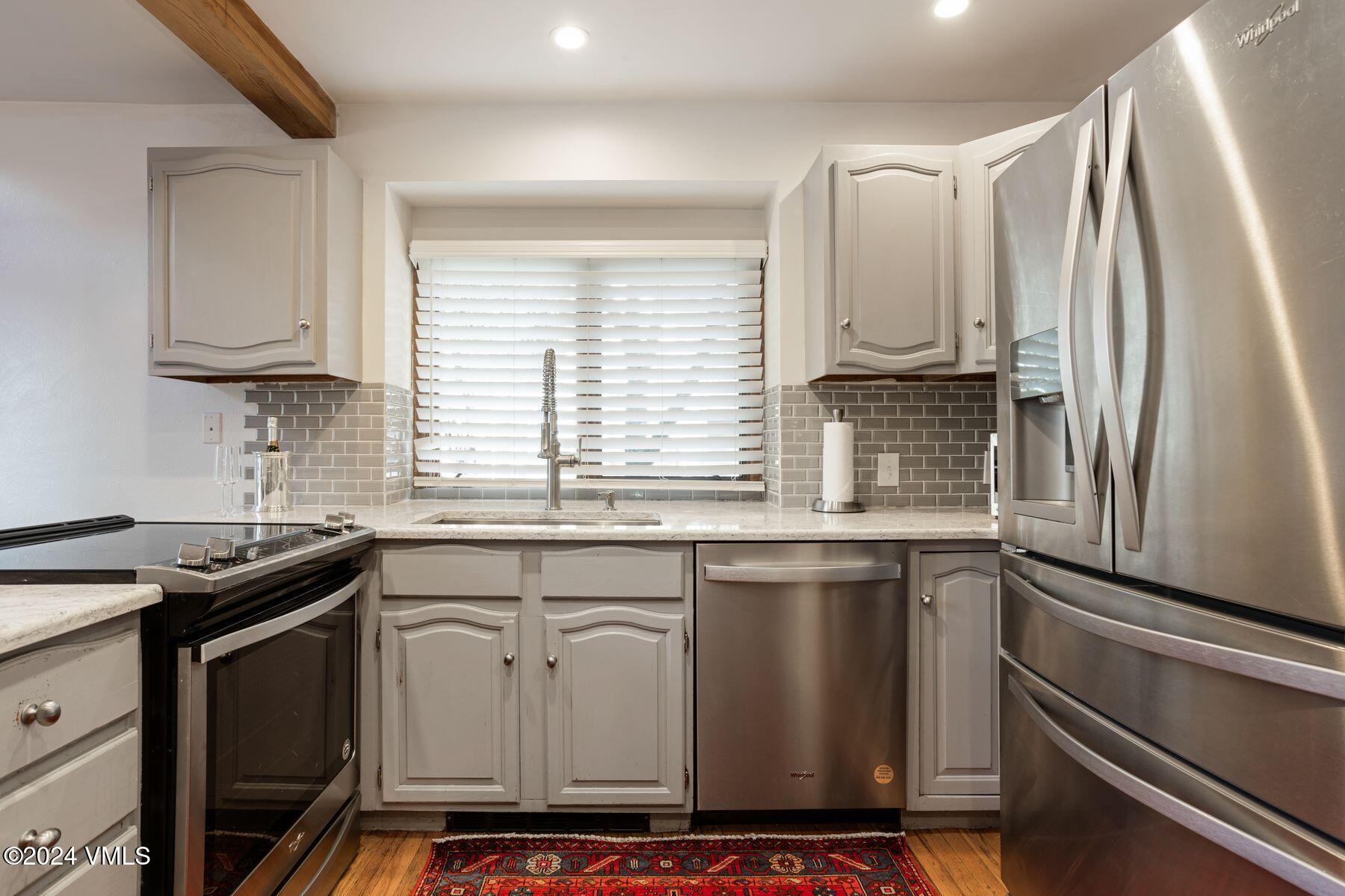 149 Deer Boulevard, Unit A Eagle-Vail, CO 81620 - Photo 10 of 22 a kitchen with stainless steel appliances granite countertop a sink stove and cabinets