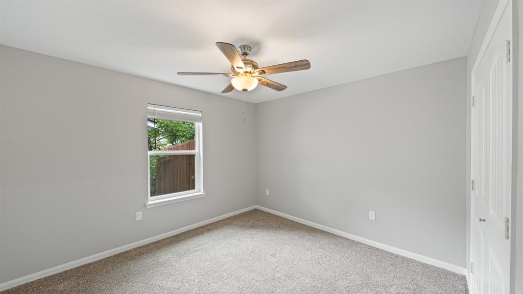 207 East McCoulskey Street Terrell, TX 75160 - Photo 12 of 29 an empty room with a window and a fan