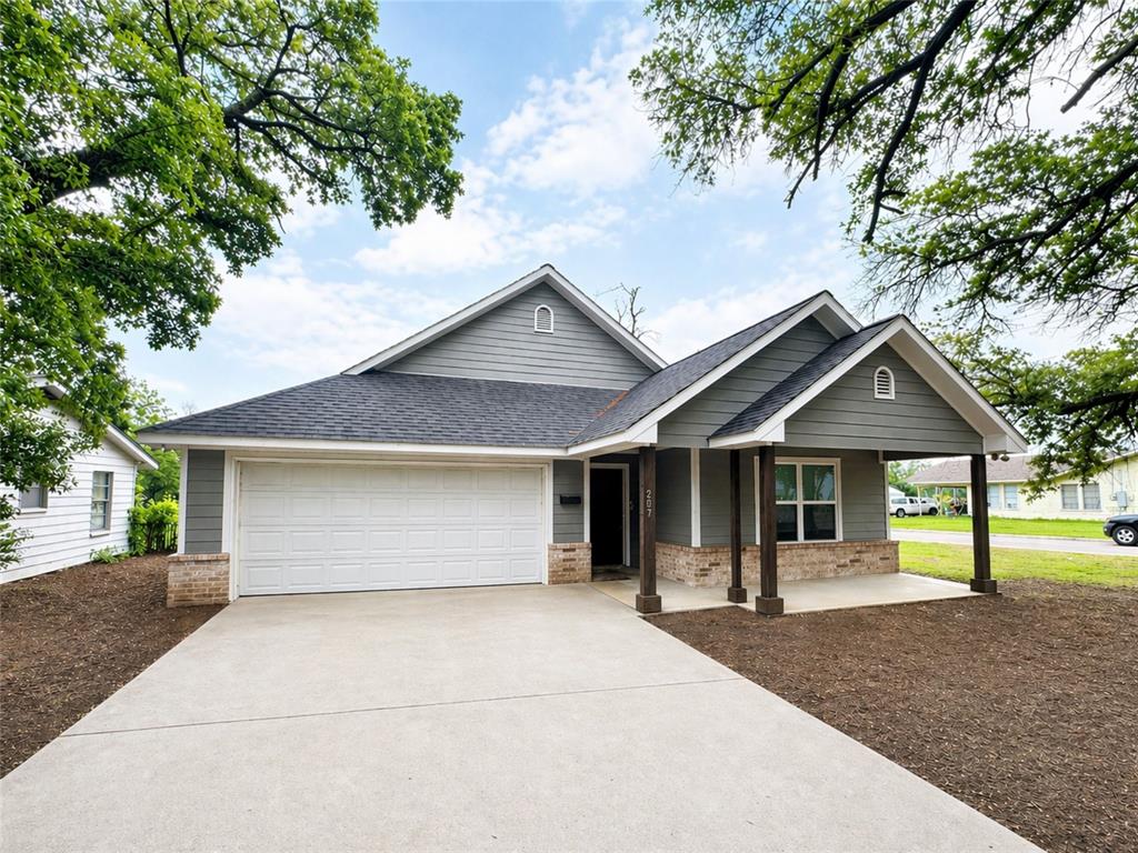 207 East McCoulskey Street Terrell, TX 75160 - Photo 2 of 29 a front view of a house with a yard and garage