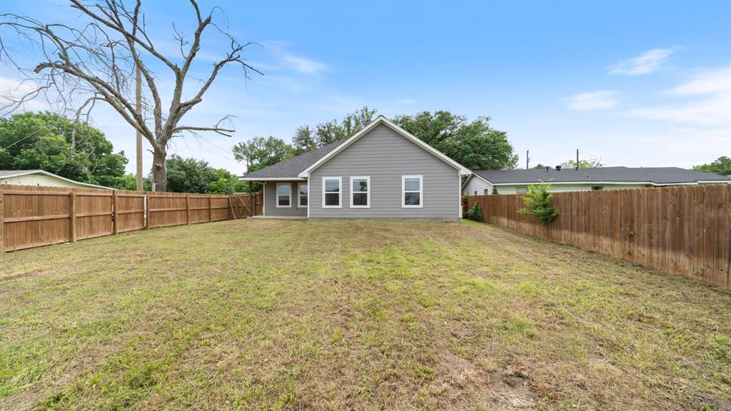 207 East McCoulskey Street Terrell, TX 75160 - Photo 23 of 29 a house with trees in the background
