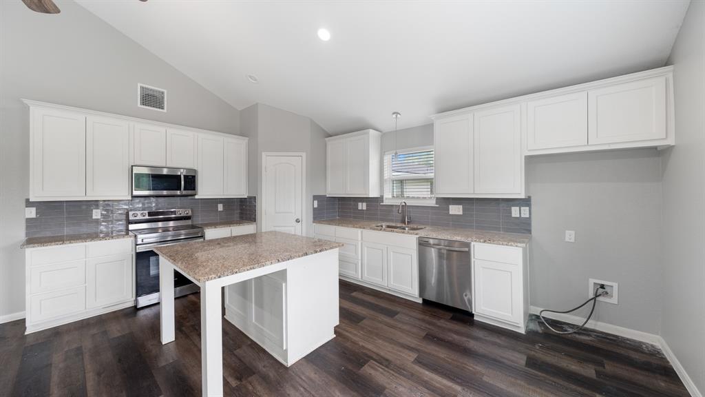 207 East McCoulskey Street Terrell, TX 75160 - Photo 7 of 29 a kitchen with granite countertop white cabinets and white appliances