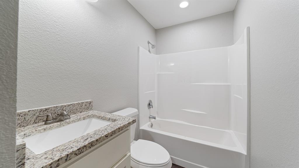 207 East McCoulskey Street Terrell, TX 75160 - Photo 10 of 29 a bathroom with a granite countertop sink toilet and shower
