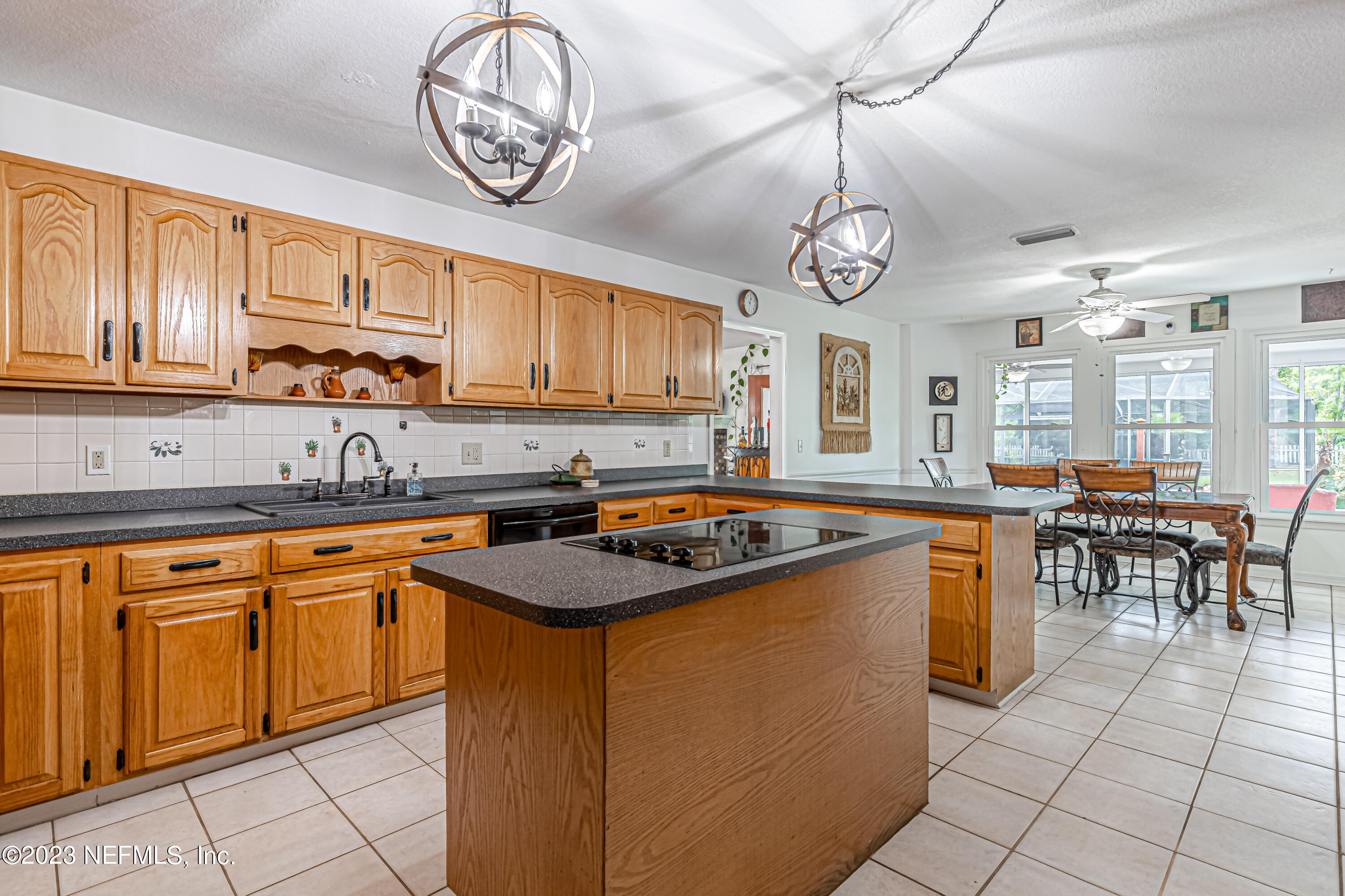 520 Roberts Road St. Johns, FL 32259 - Photo 12 of 81 a kitchen with stainless steel appliances granite countertop a sink a stove a dining table and chairs with wooden floor