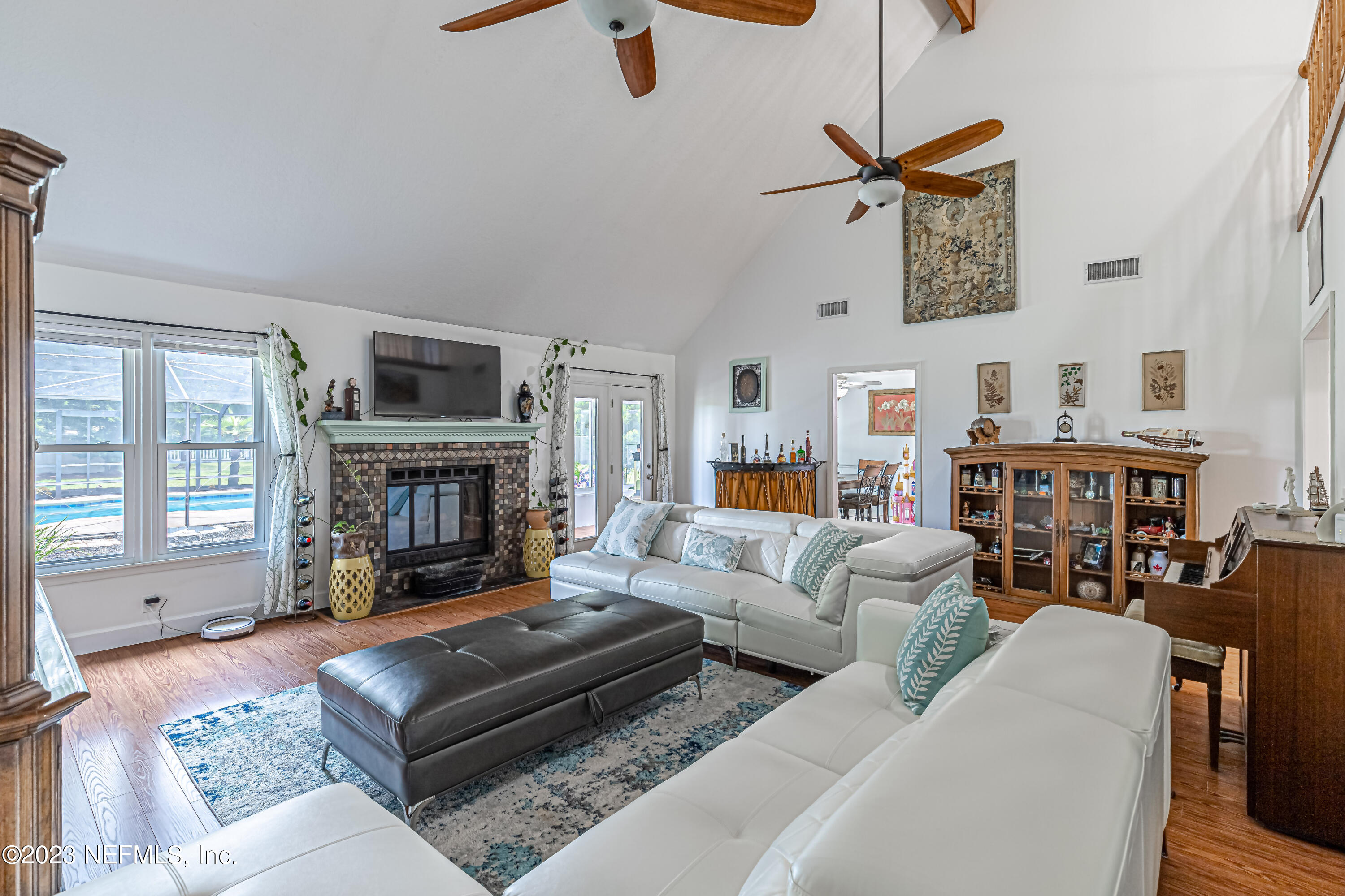 520 Roberts Road St. Johns, FL 32259 - Photo 23 of 81 a living room with furniture a fireplace and a flat screen tv