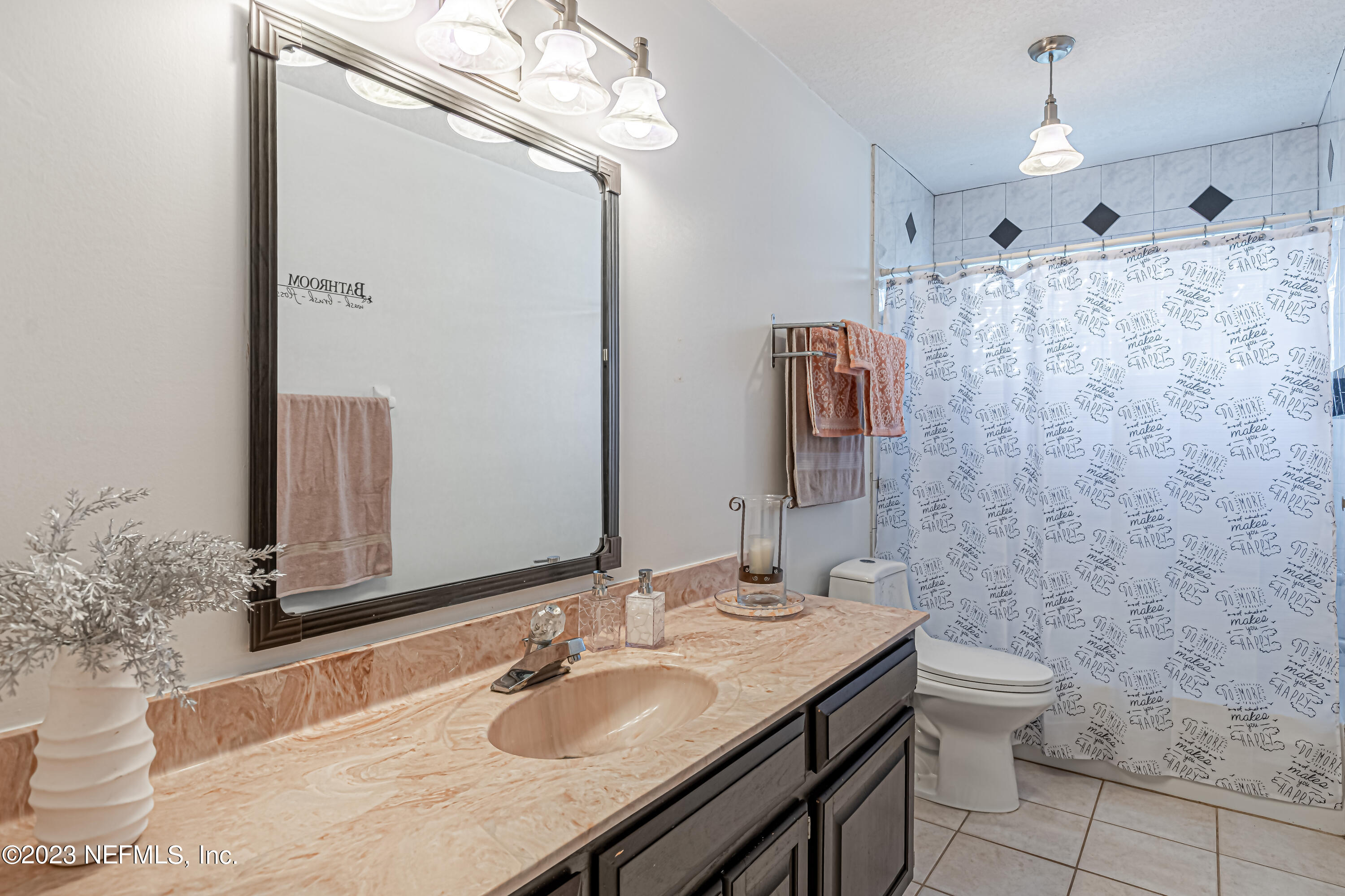520 Roberts Road St. Johns, FL 32259 - Photo 40 of 81 a bathroom with a granite countertop sink a toilet a mirror and shower
