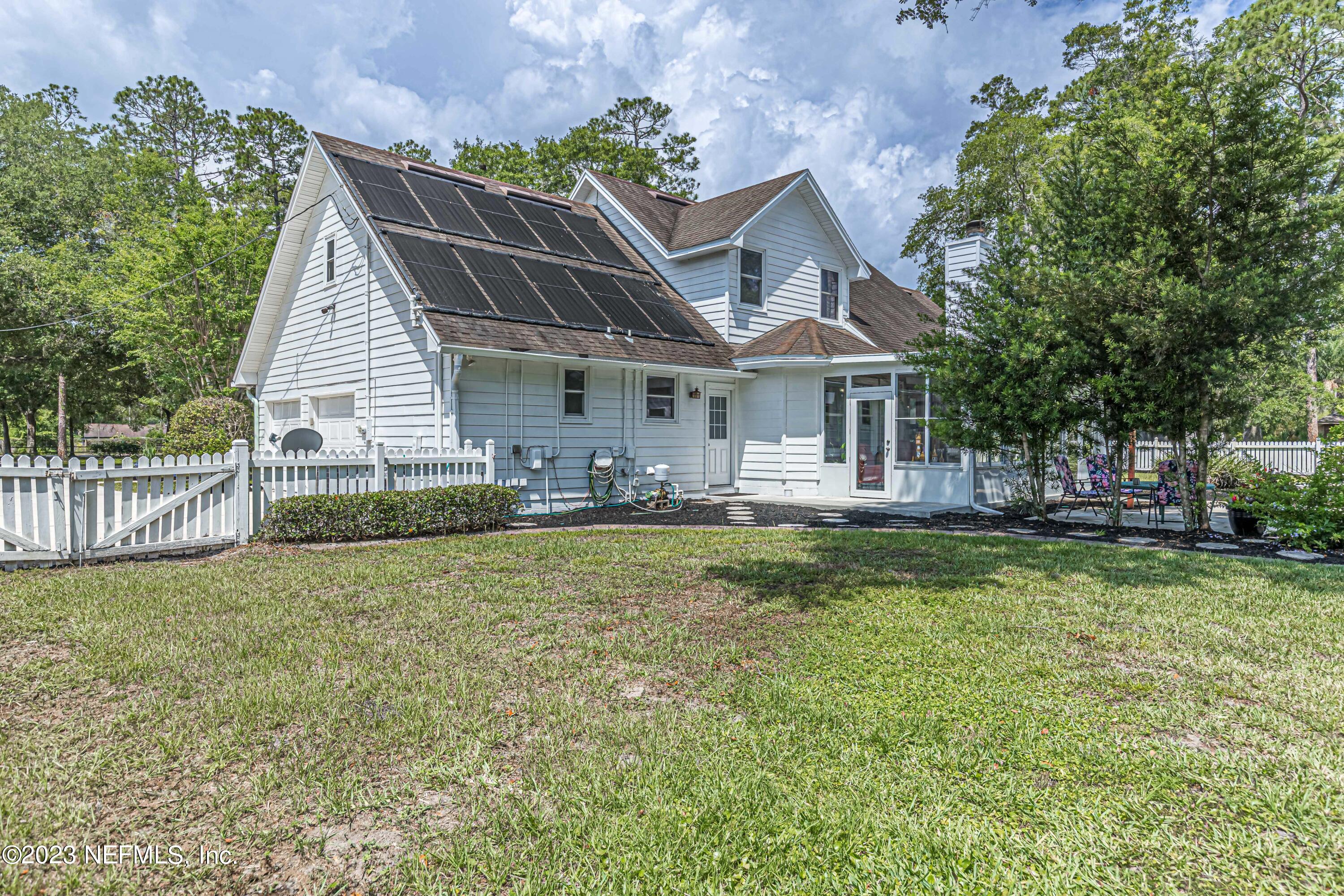 520 Roberts Road St. Johns, FL 32259 - Photo 50 of 81 a front view of a house with a yard garage and outdoor seating