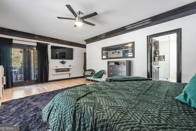 a bathroom with a double vanity sink a toilet a mirror and shower
