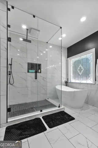 a bathroom with a bathtub and large window