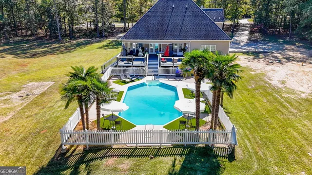 a view of swimming pool with sitting area and furniture