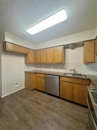 an empty room with windows and ceiling fan