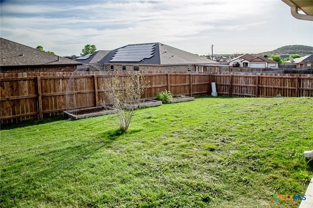a view of a house with a yard and sitting area