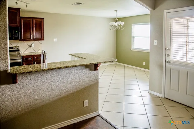a view of a kitchen cabinets and a counter top space