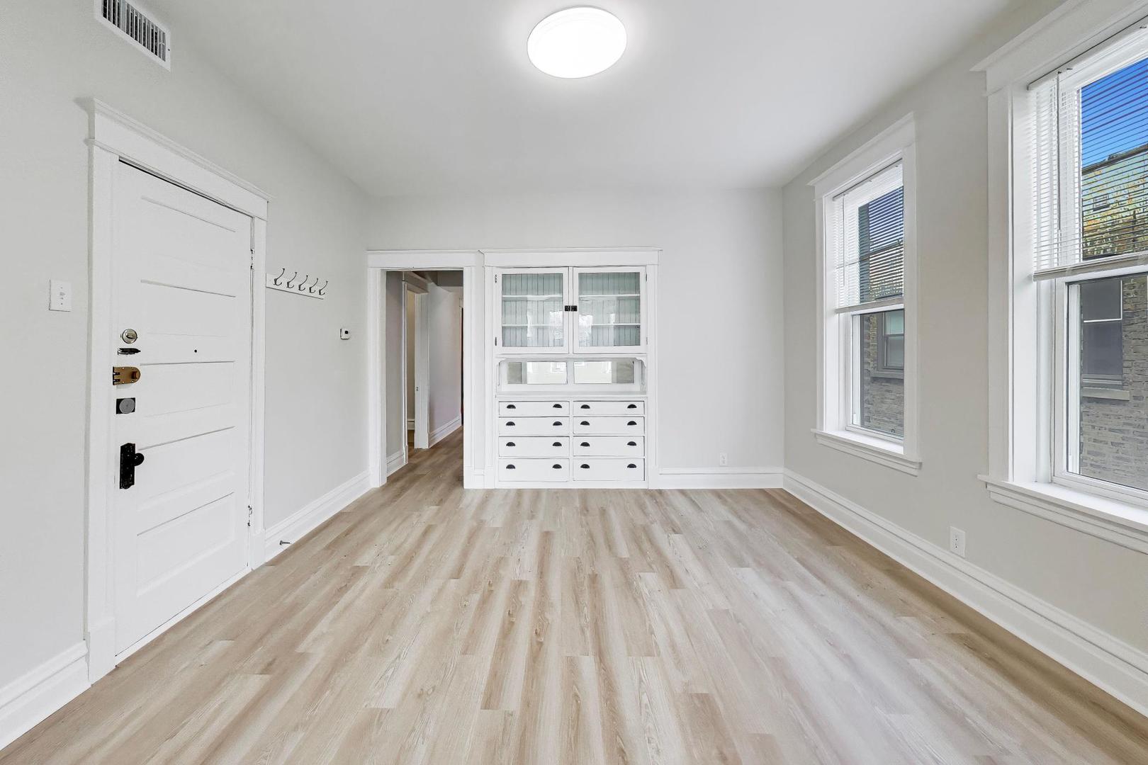 1646 West Byron Street, Unit 2F Chicago, IL 60613 - Photo 11 of 27 wooden floor in an empty room with a window