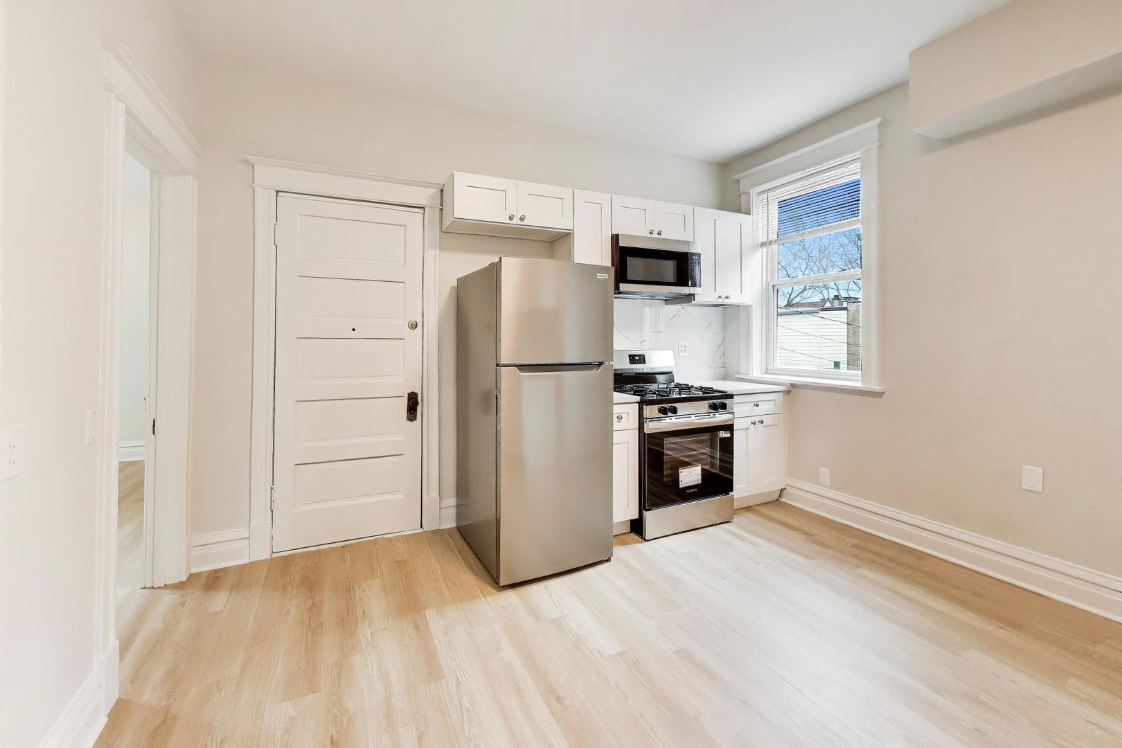 1646 West Byron Street, Unit 2F Chicago, IL 60613 - Photo 12 of 27 a kitchen with stainless steel appliances a refrigerator and a stove