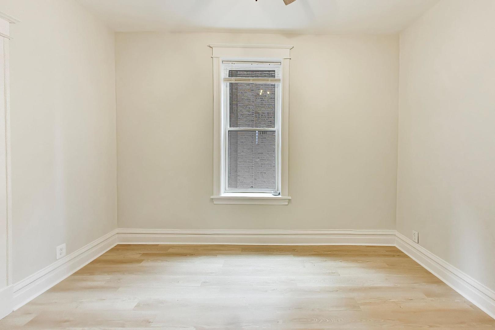1646 West Byron Street, Unit 2F Chicago, IL 60613 - Photo 16 of 27 a view of a small space with wooden floor and a window
